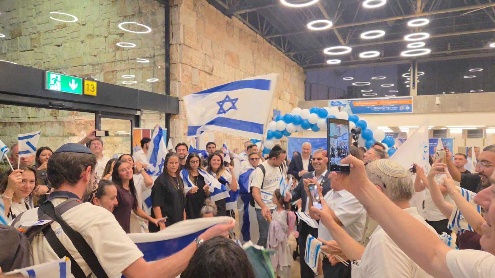 Jewish families celebrating arrival at airport