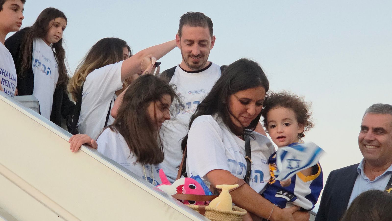 Families boarding plane to Israel